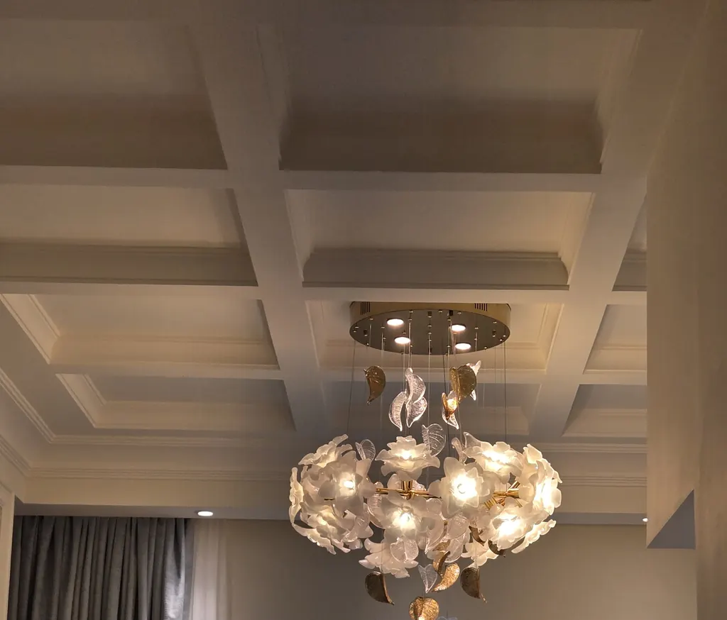 Coffered ceiling with a crystal chandelier over the living area