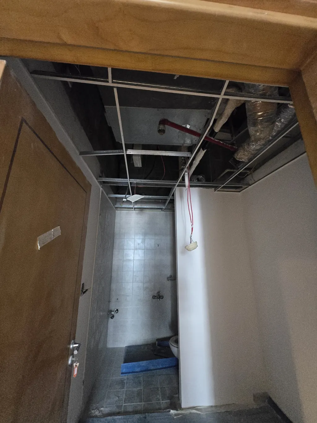 The corridor with its ceiling opened and the new frame going in