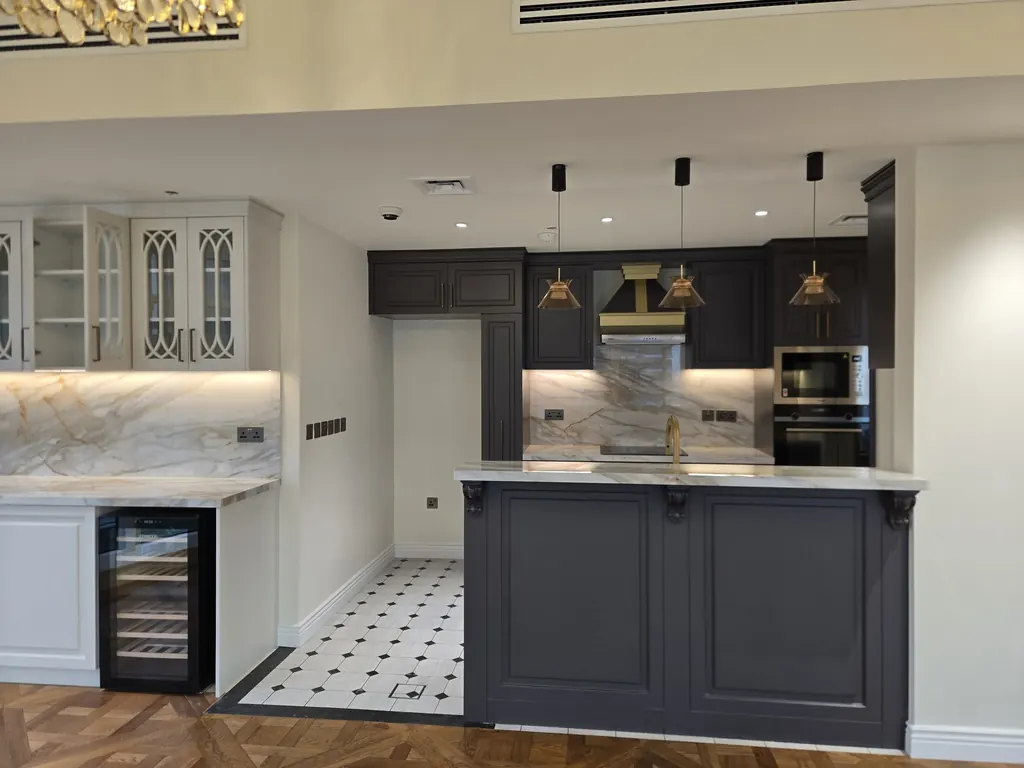 Panelled kitchen in charcoal with a marble-look worktop and octagon-and-dot floor tile