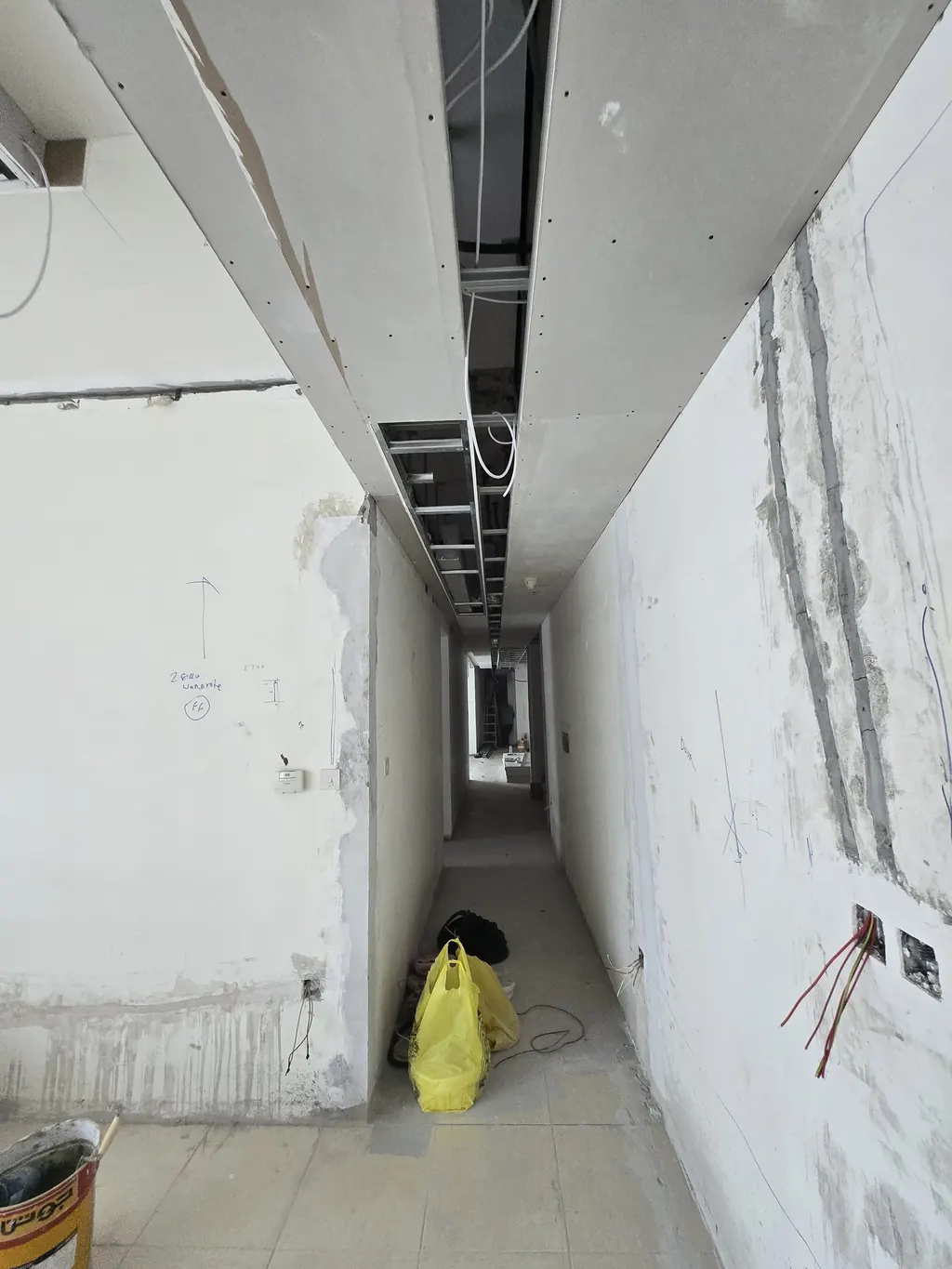 The same corridor during the works, stripped back with the new ceiling frame going in